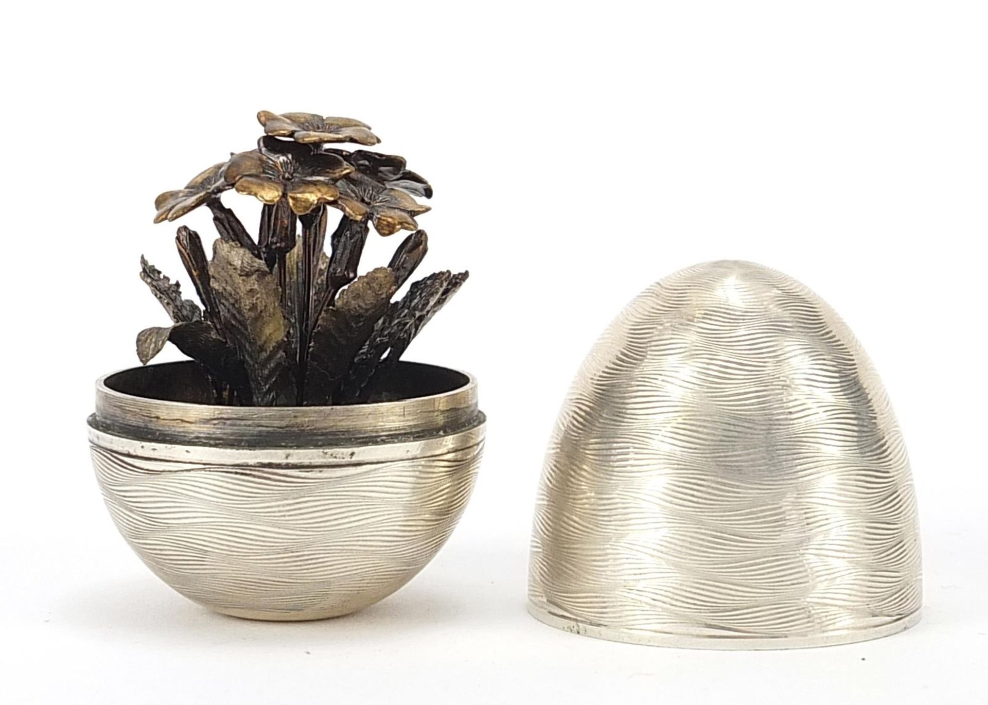 Nicholas Plummer, Elizabeth II silver surprise egg housing a floral posy in the manner of Stuart