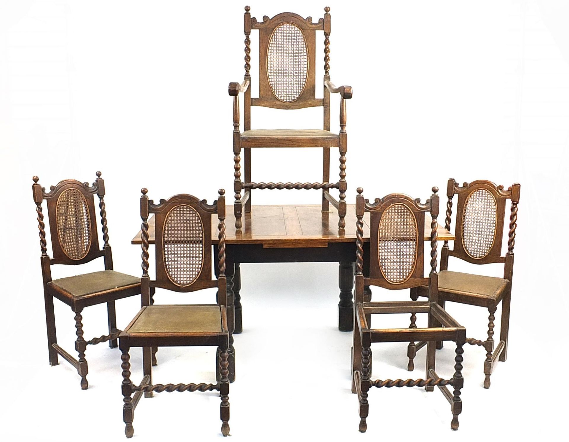 Oak draw leaf dining table and five barley twist dining chairs with bergere backs, the table 76cm