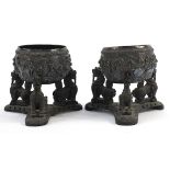 Pair of Burmese unmarked silver bowls embossed with figures raised on hardwood stands, each bowl