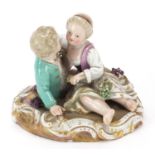 Meissen, German porcelain figure group of two young lovers with grapes, 9cm wide