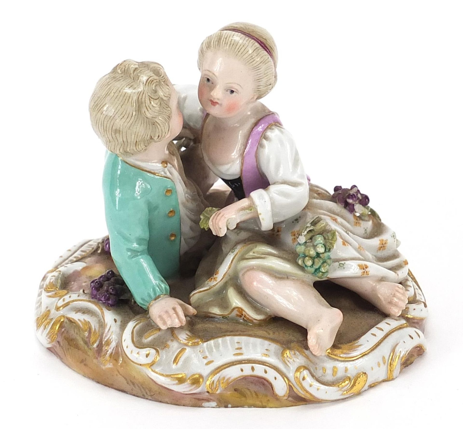 Meissen, German porcelain figure group of two young lovers with grapes, 9cm wide