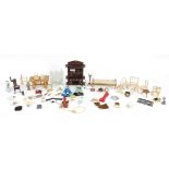 Assorted doll's house furniture including ceramic fireplace, wooden dresser and miniature dolls, the