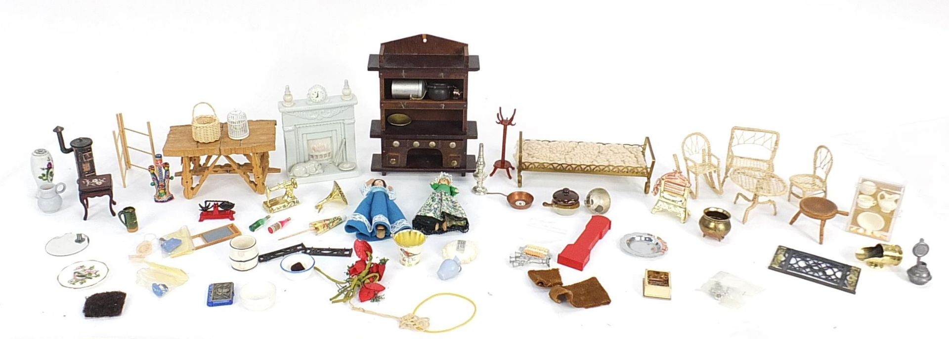 Assorted doll's house furniture including ceramic fireplace, wooden dresser and miniature dolls, the