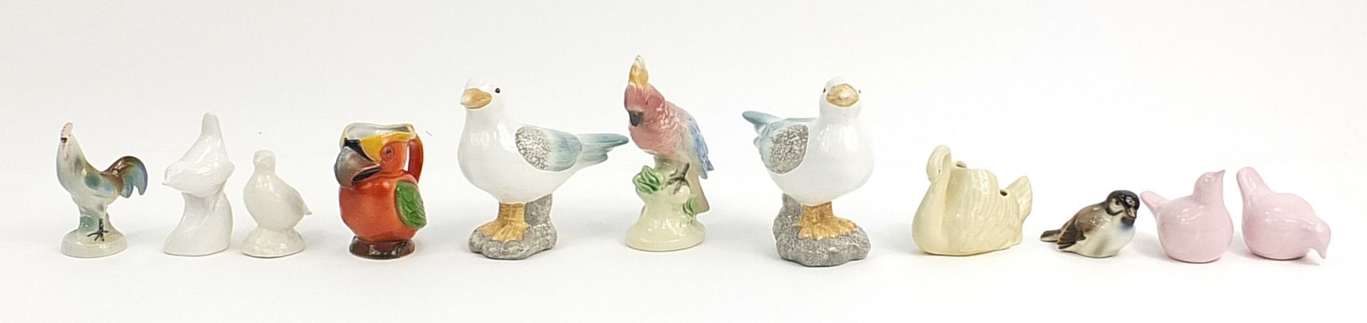 Selection of ceramic birds including parrot, swans, seagulls and cockerel, the largest 16cm high