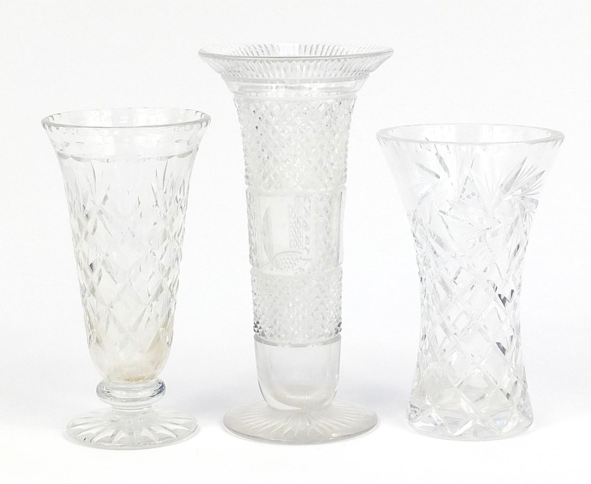 Three cut glass vases, the largest 26cm high