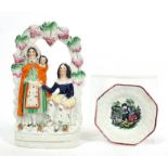 Staffordshire figure and a Staffordshire childs plate, the largest 26cm high