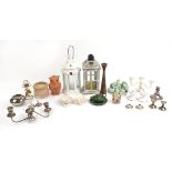 Selection of candle holders including large wooden lantern, ceramic pebbles on a beach sculpture and