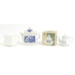 Three collectable teapots including a cubed teapot, blue and white Willow pattern and a boxed