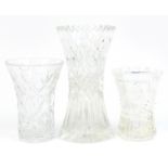 Three crystal cut glass vases, the largest 25cm high