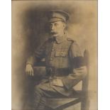 Black and white print World War I military soldier in uniform, mounted in a carved oak frame,