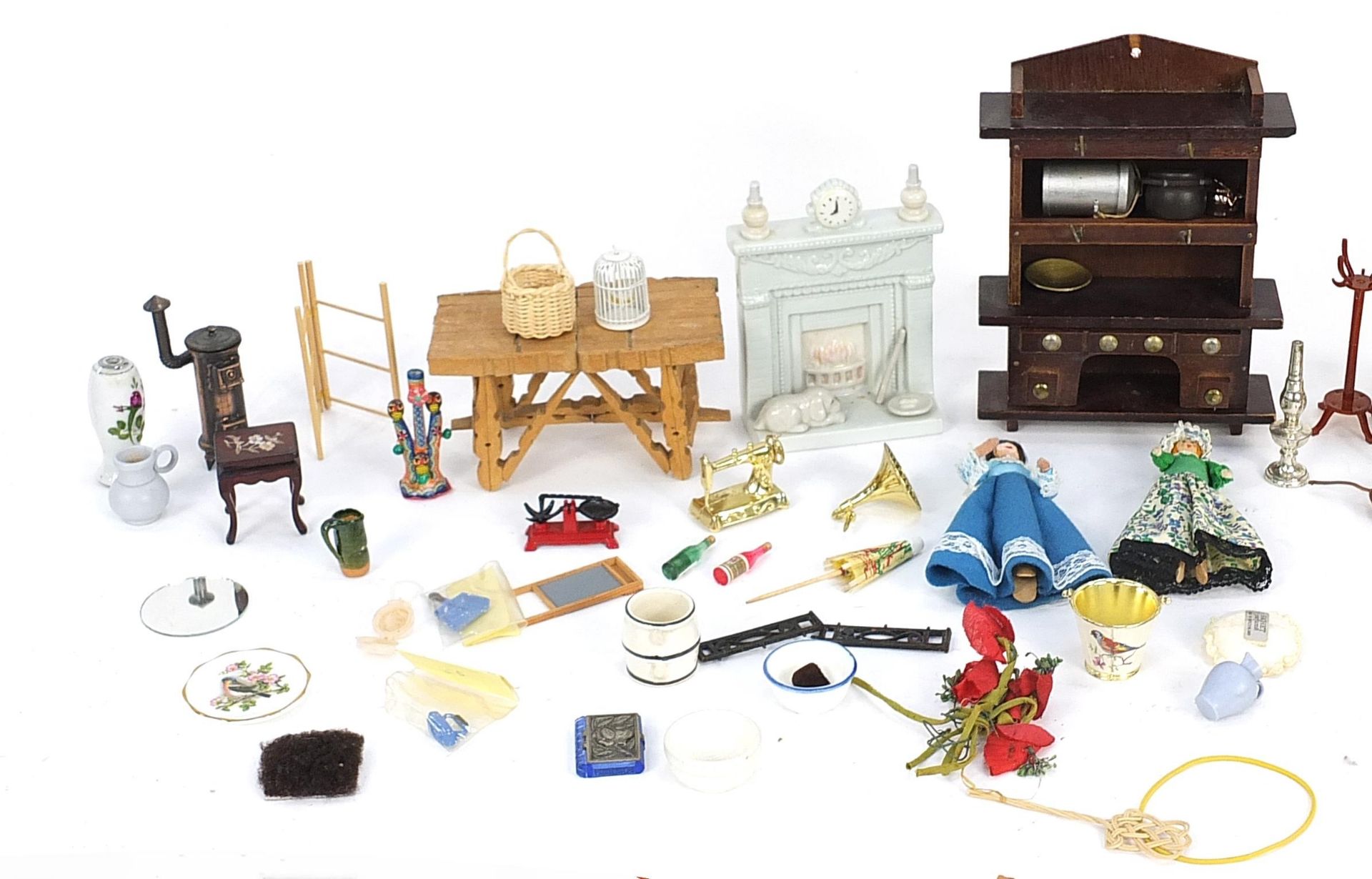 Assorted doll's house furniture including ceramic fireplace, wooden dresser and miniature dolls, the - Image 2 of 3