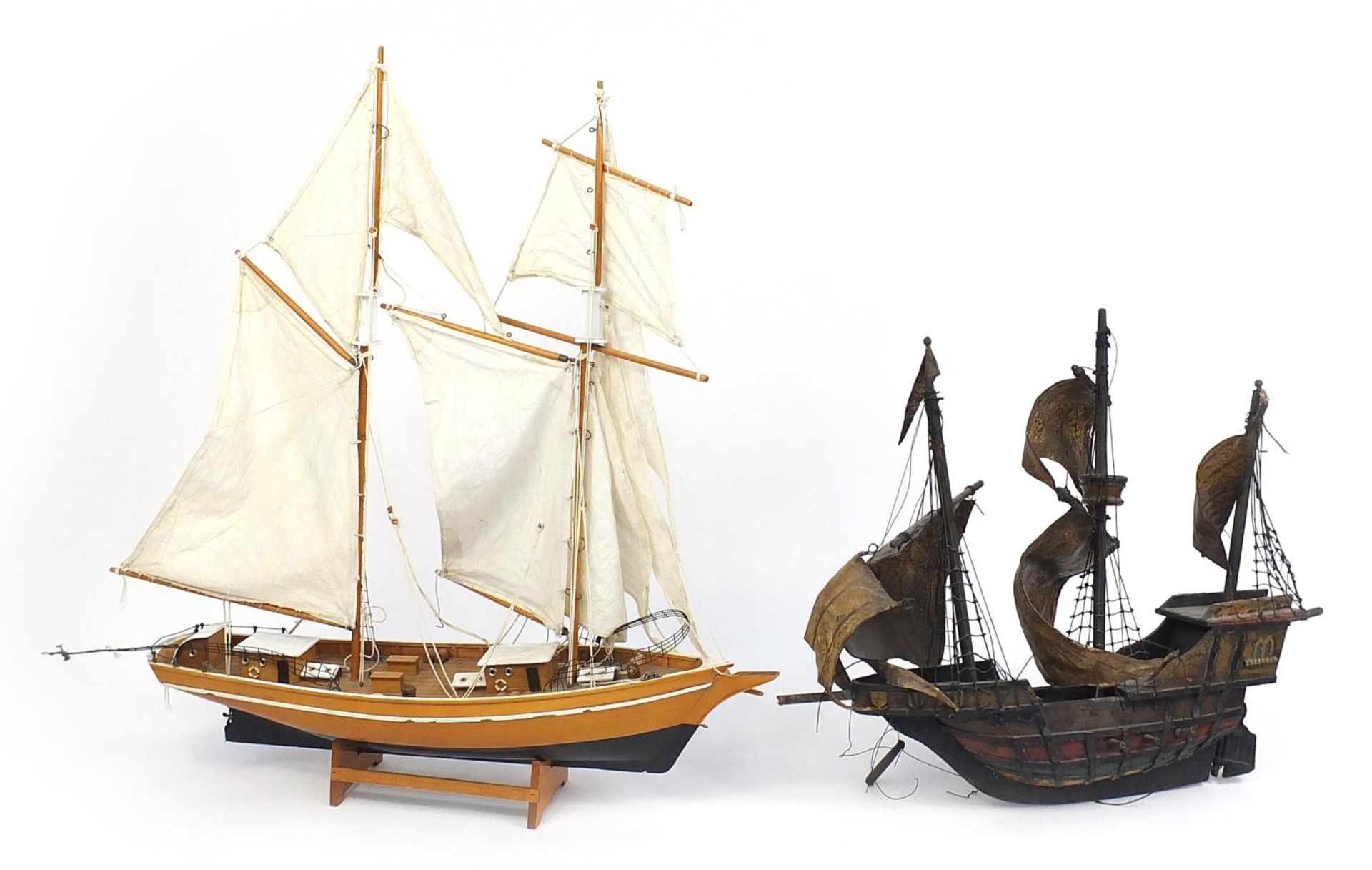 Wooden model of a galleon and wooden yacht with cloth sails, the largest 63cm in length