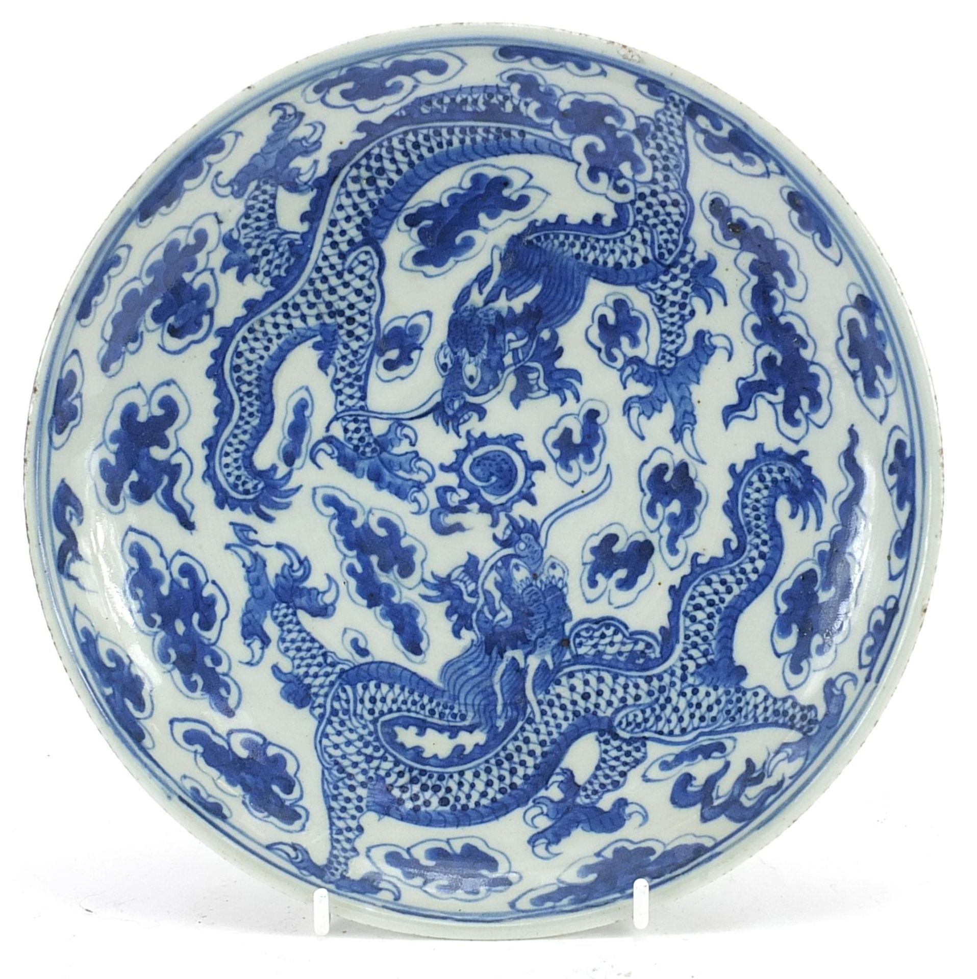 Chinese blue and white porcelain plate hand painted with two dragons chasing a flaming pearl amongst