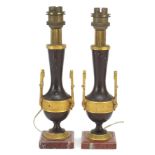 Pair of French patinated bronze and ormolu candlesticks converted to table lamps, each raised on