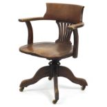 Edwardian oak revolving captain's chair, 82cm high