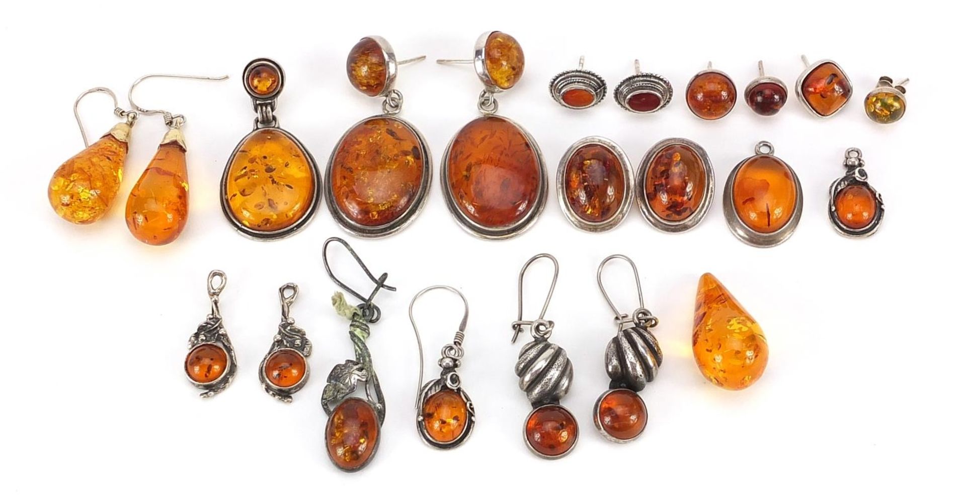 Collection of silver mounted natural amber earrings, the largest 4.5cm high, total weight 57.4g