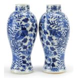 Pair of Chinese blue and white porcelain baluster vases hand painted with dragons amongst flowers,