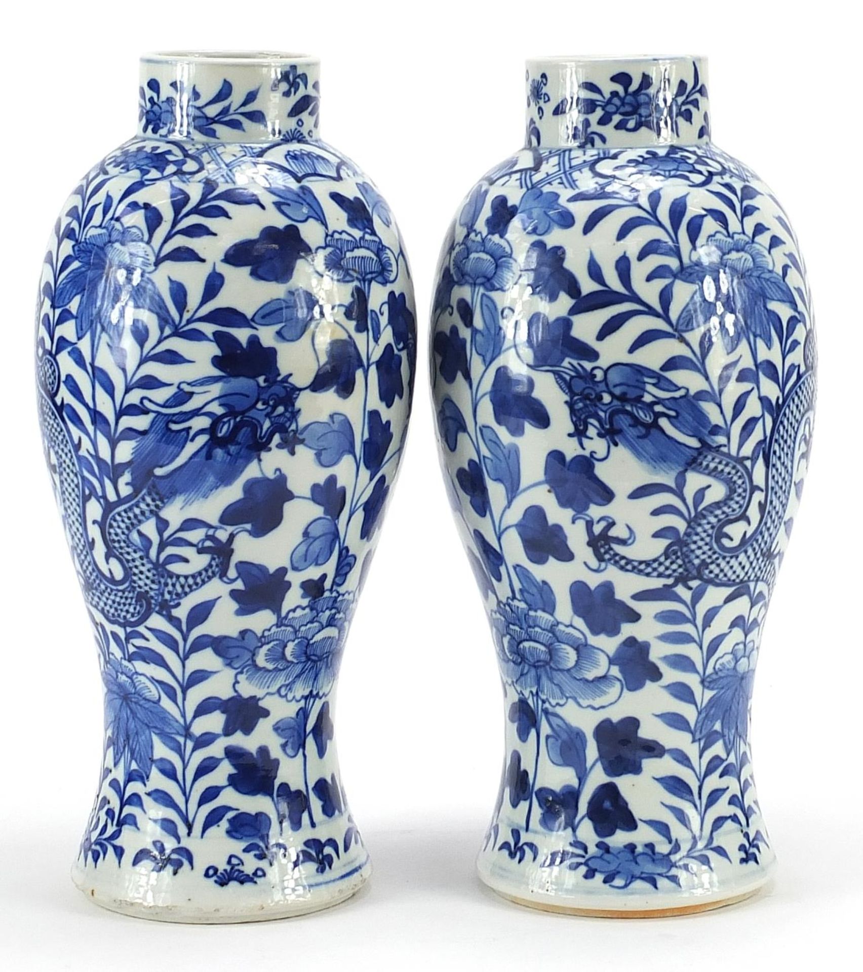 Pair of Chinese blue and white porcelain baluster vases hand painted with dragons amongst flowers,