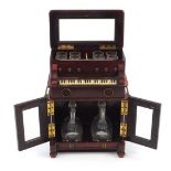 Novelty 19th century hardwood musical liqueur cabinet in the form of a piano with lift up top and