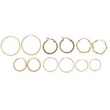 Six pairs of 9ct gold and yellow metal hoop earrings, the largest 2.4cm in diameter, 3.7g