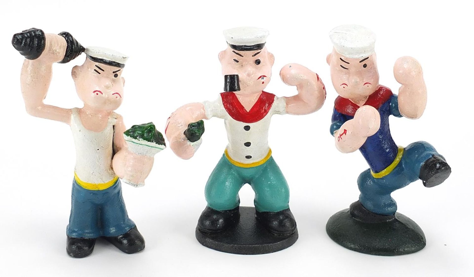 Three painted cast iron figures of Popeye, the largest 16cm high