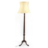 Carved mahogany standard lamp with lion paw feet and beige silk lined shade, 183cm high