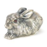 Silver recumbent rabbit paperweight with ruby eyes, impressed Russian marks to the base, 6.8cm in
