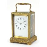 19th century gilt brass cased carriage clock striking on a bell with enamelled dial having Roman