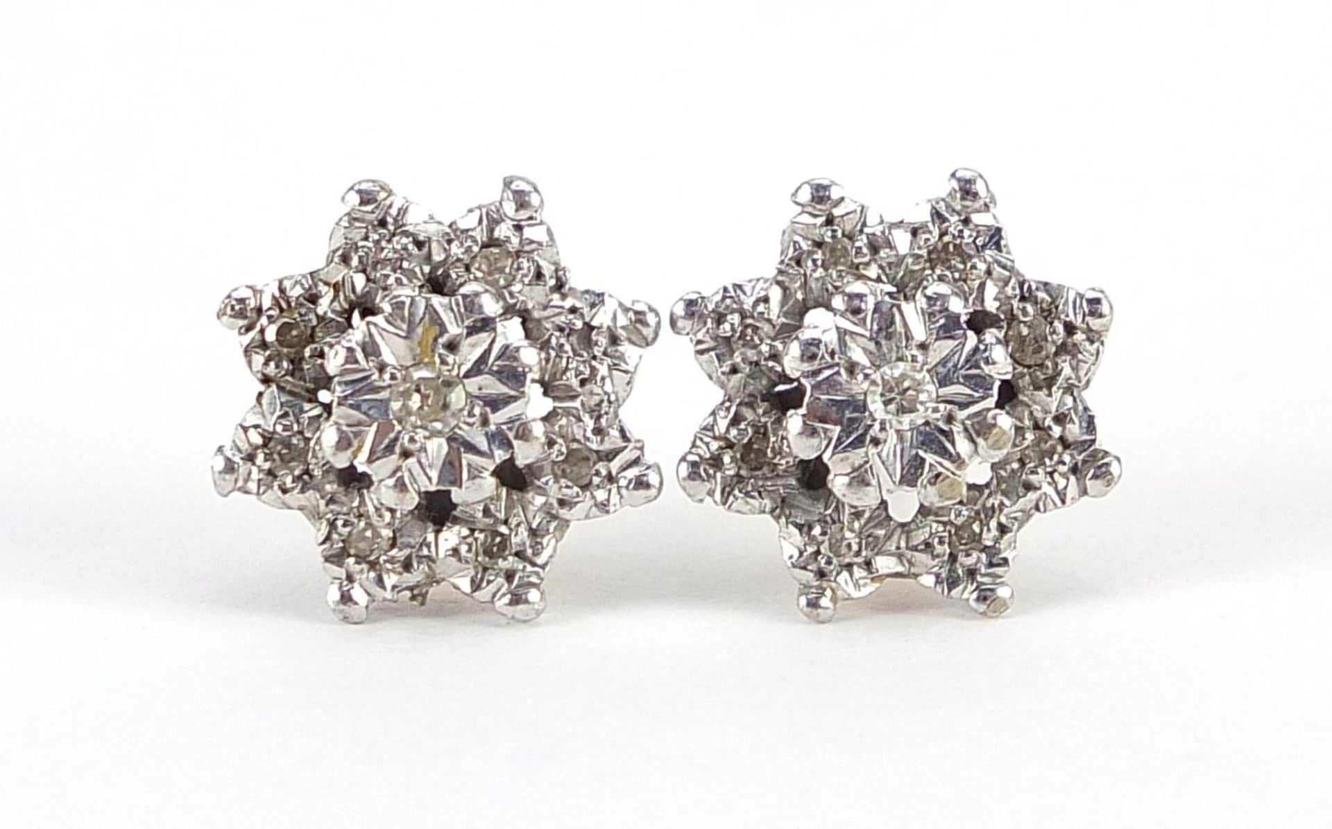 Pair of unmarked two tone gold diamond flower head earrings, 1.2cm in diameter, 3.1g