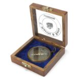 Military interest brass sundial compass housed in a glazed hardwood case, 11cm wide