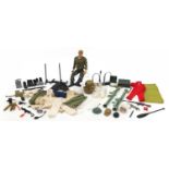 Vintage Action Man figure with a collection of weapons and accessories, 29cm high