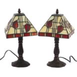 Pair of Tiffany design bronzed table lamps with leaded glass shades, 24.5cm high