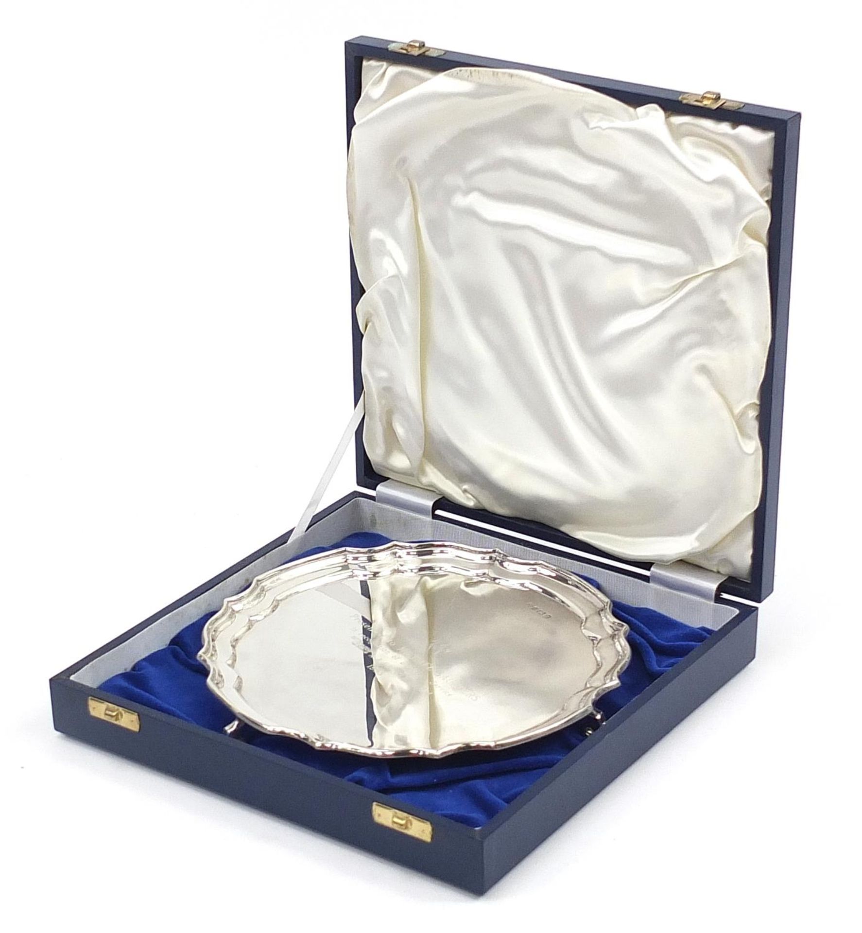 Elkington & Co Ltd, Elizabeth II circular silver salver raised on three scrolled feet with