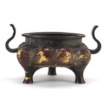 Chinese gold splashed patinated bronze tripod censer with twin handles, 16cm wide