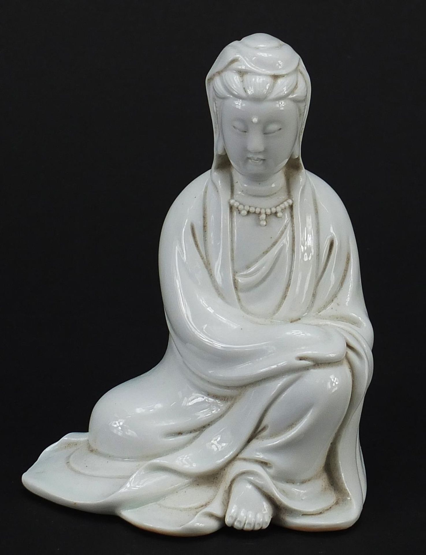 Chinese porcelain figure of Guanyin having a blanc de chine glaze, 12.5cm high