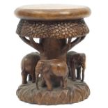 Indian wood occasional table carved with elephants under a tree, 41cm high
