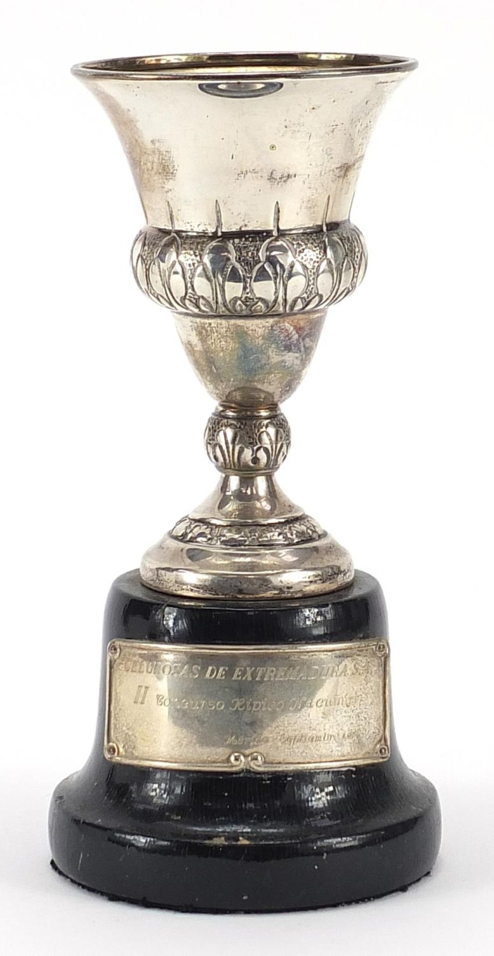 Spanish silver equestrian interest trophy raised on an ebonised wood base, 20cm high, total weight