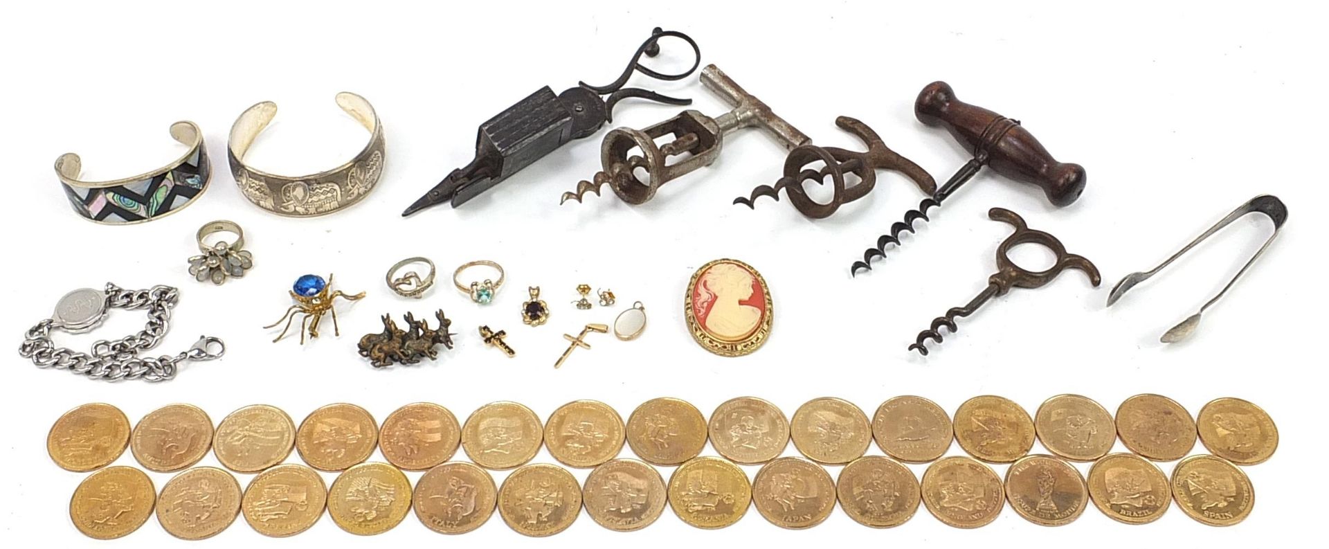 Objects including antique corkscrews, football '98 World Cup tokens and costume jewellery