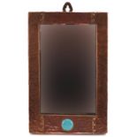 Attributed to Liberty & Co, Arts & Crafts beaten copper wall mirror with inset Ruskin type cabochon,