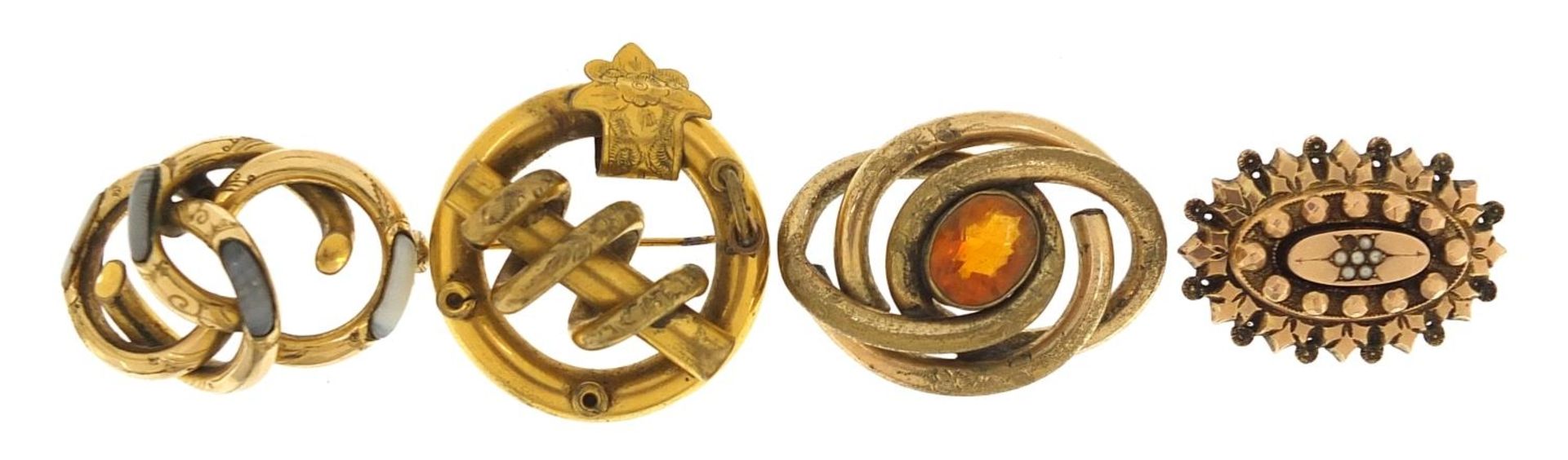 Four antique yellow metal brooches, some set with stones including citrine, agate and seed pearls,