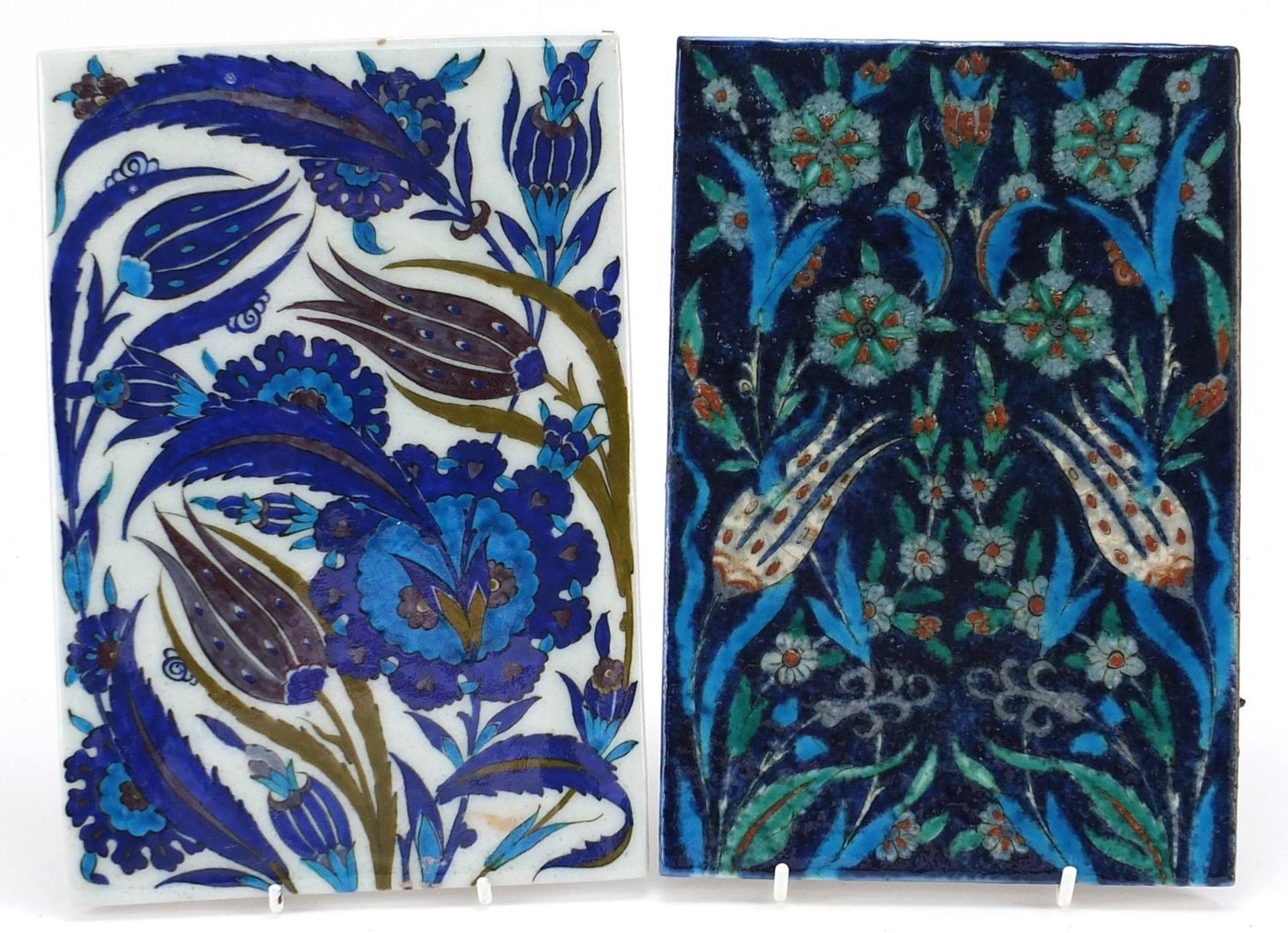 Pair of Turkish Iznik pottery tiles hand painted with flowers, each approximately 24cm x 16.5cm
