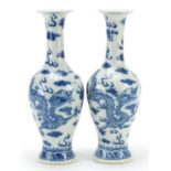 Pair of Chinese blue and white porcelain vases hand painted with dragons amongst clouds, four figure