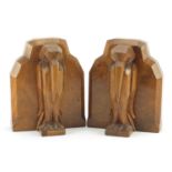 Pair of Art Deco walnut bookends carved with stylised pelicans, each 15cm high