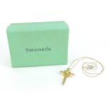 Tiffany & Co silver and 18ct gold cross pendant on a silver necklace with box, 3.3cm high and 42cm
