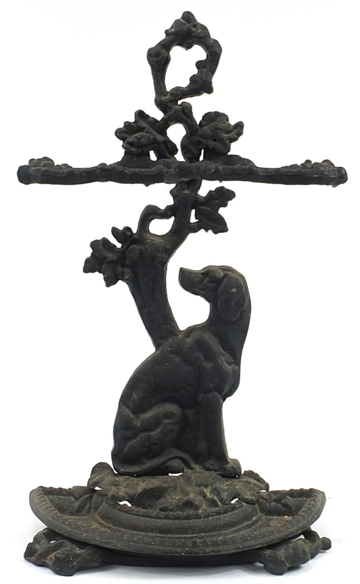 Cast iron stick stand in the form of a dog seated under a tree, 70cm high