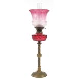 Victorian brass oil lamp with cranberry glass reservoir and shade, impressed Hinks & Sons, 69cm high