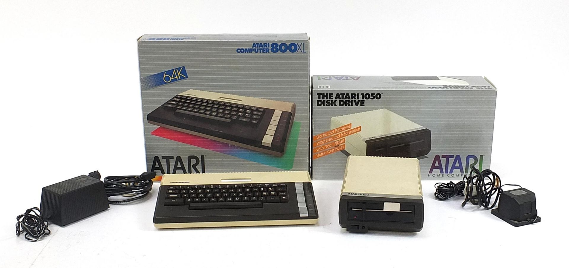 Atari 800XL computer and 1050 disc drive with boxes