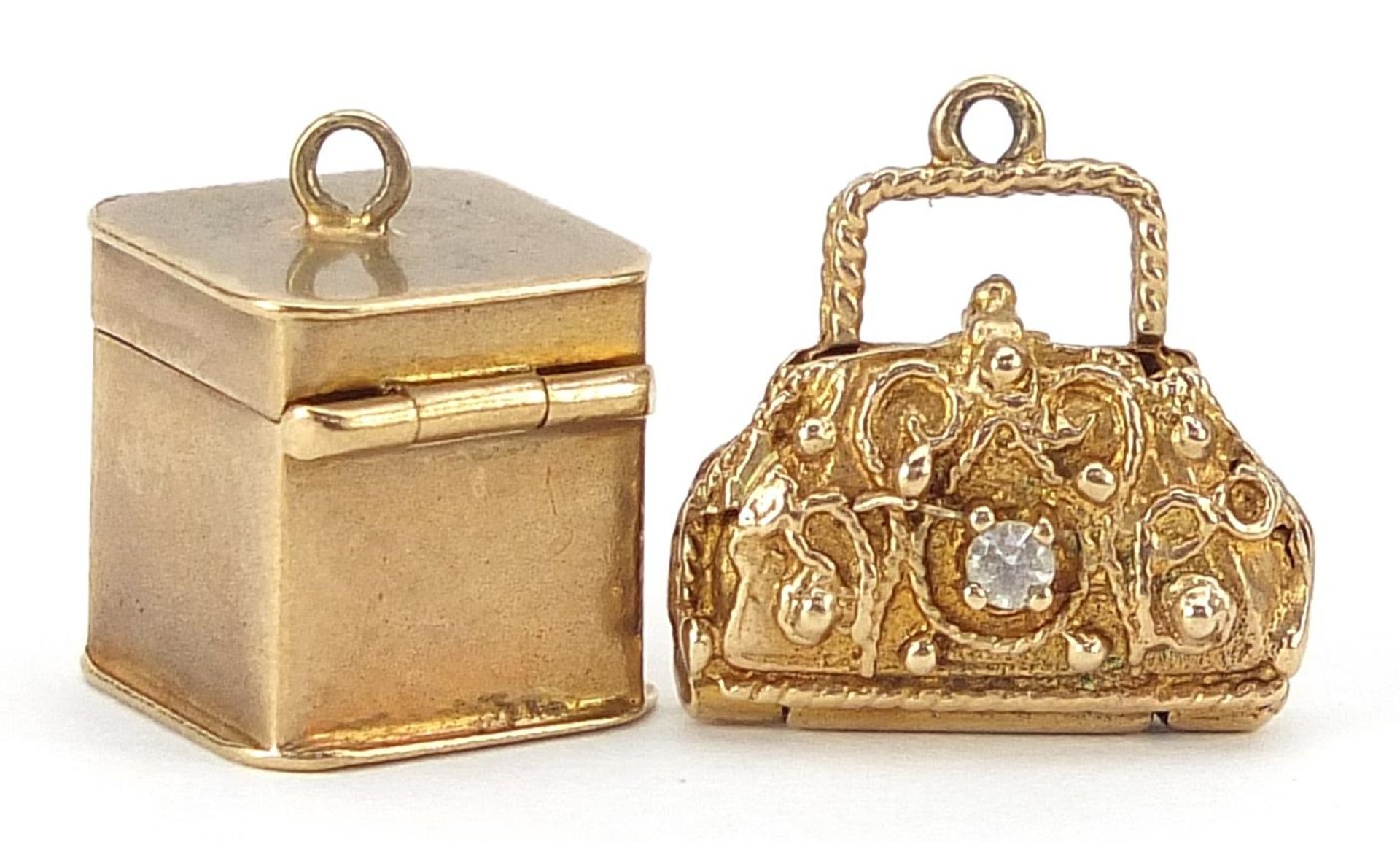 9ct gold first aid box charm and unmarked gold handbag charm set with a white sapphire and ruby, the - Image 2 of 3