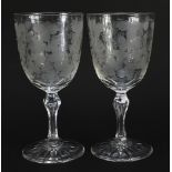 Pair of Edwardian cut glasses etched with leaves and berries, each 18.5cm high