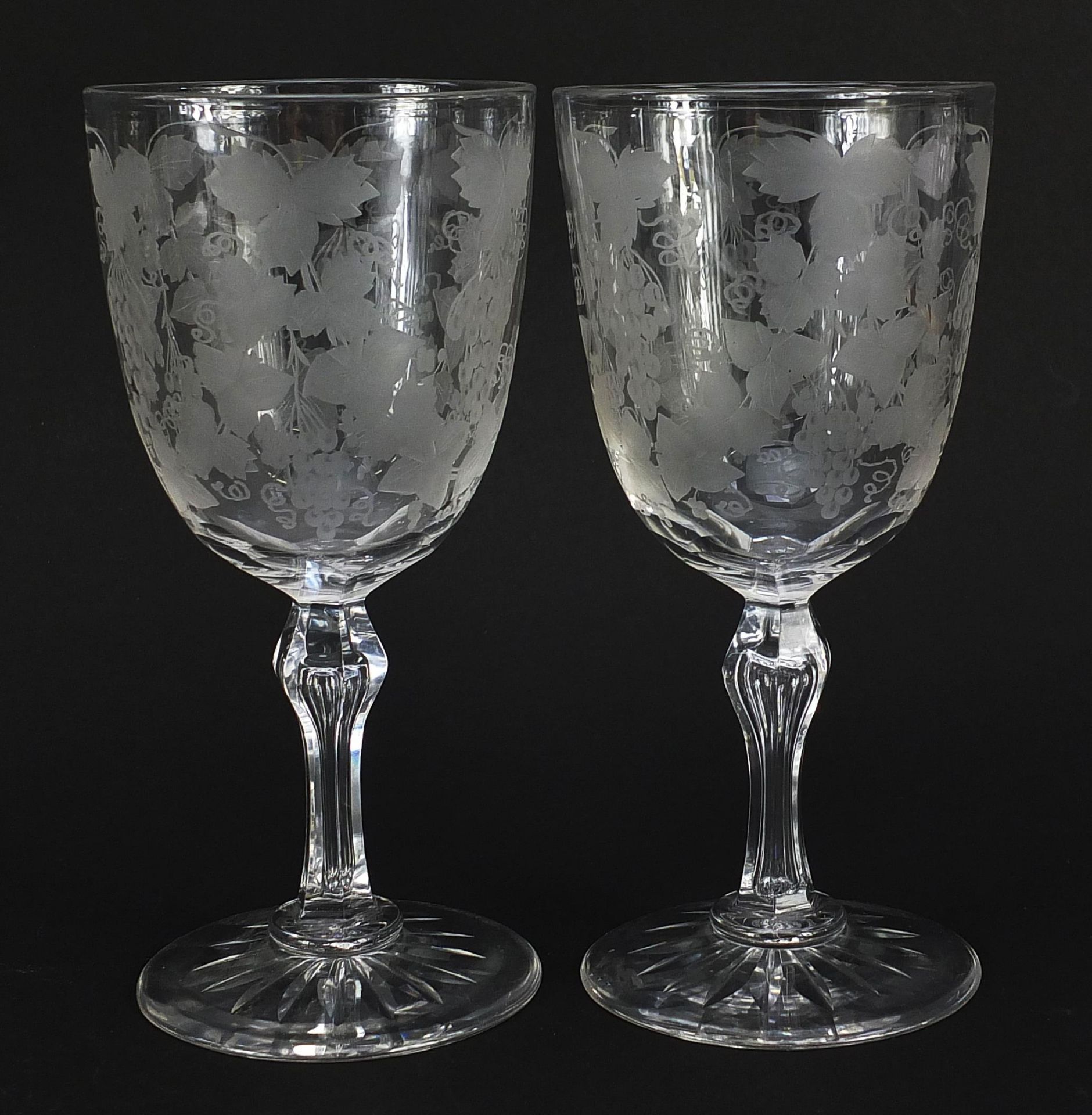 Pair of Edwardian cut glasses etched with leaves and berries, each 18.5cm high